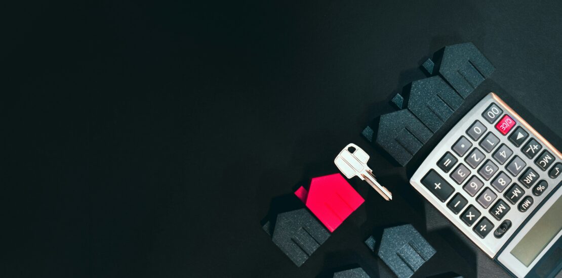Calculator and house key representing mortgage stress test qualification in the GTA